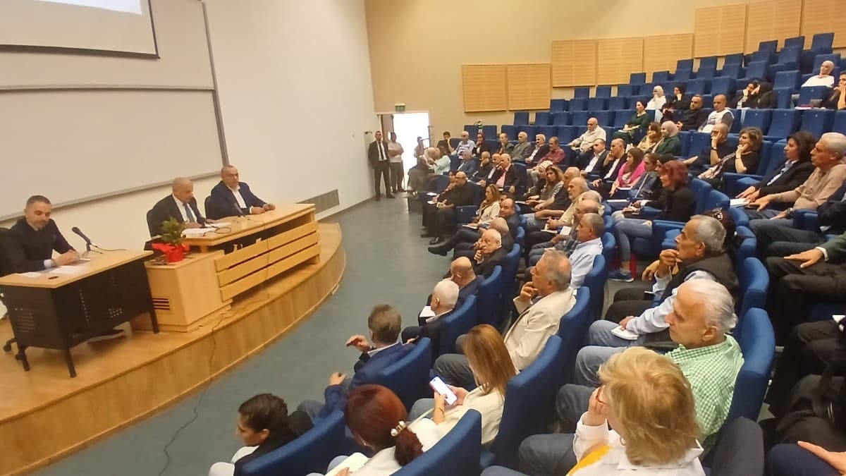 Contract professors of the Lebanese University meeting in a conference hall to discuss renewing their strike.